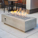 Natural Grey Cove 54 Linear Gas Fire Pit Table Installed with Tumbled Lava Rock Burner On