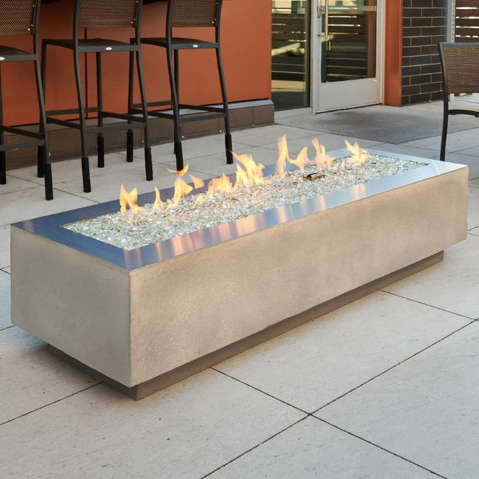 Natural Grey Cove 72 Linear Gas Fire Pit Table at the Front Yard with Clear Tempered Fire Glass Gems plus Fire Burner On and Stainless Steel Trim Overlay