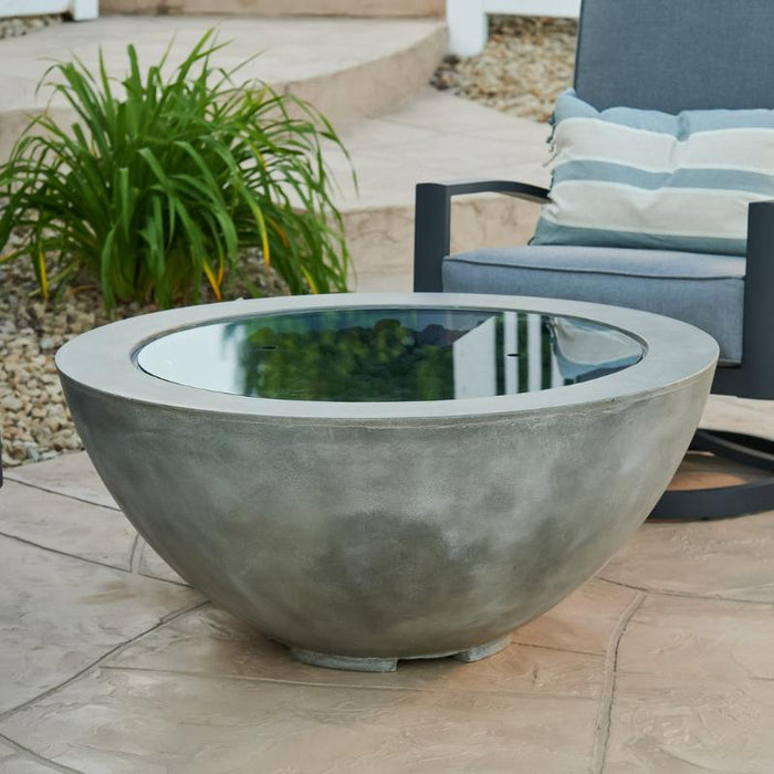 Outdoor Greatroom Natural Grey Cove 42 Round Gas Fire Pit Bowl Placed at Front Yard with Clear Tempered Fire Glass Gems plus Fire Burner On and  and Grey Glass Burner Cover