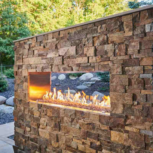 Ready-to-Finish See Through Outdoor Fireplace Installed at Patio with Tumble Lava Rock  Fire Burner On plus Glass Wind Guard Panel