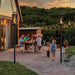 Tempest Lanterns Mounted in Ground surrounding family eating dinner outside