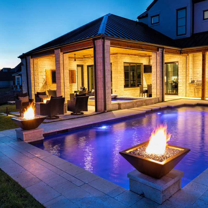 The Malibu Square Fire Bowl in Concrete Placed at the Poolside with Black Reflective Fire Glass plus Bullet Burner On