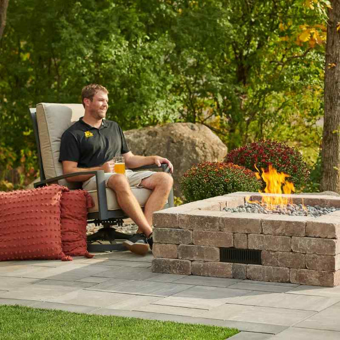 The Outdoor Greatroom Bronson Block Square Gas Fire Pit Kit Installed at Front Yard with Guess plus Tumbled Lava Rock Fire Burner On