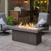 The Outdoor Greatroom Midnight Mist Key Largo Linear Gas Fire Pit Table Placed at the Deck with Clear Tempered Fire Glass Gems plus Fire Burner On