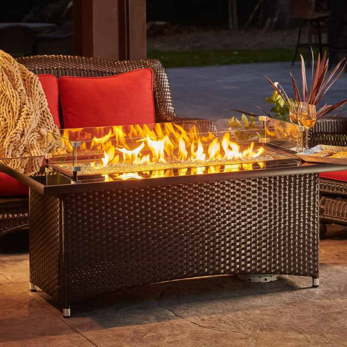 The Outdoor Greatroom Montego Linear Gas Fire Pit Table Installed at Front Yard with Clear Tempered Fire Glass Gems plus Fire Burner On and Glass Wind Guard