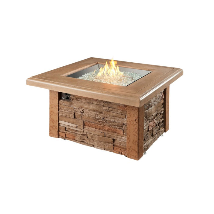 The Outdoor Greatroom Sierra Square Gas Fire Pit Table with Clear Tempered Fire Glass Gems plus Fire Burner On