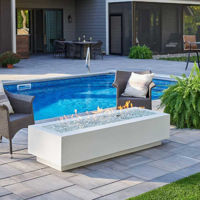 White Cove 72 Linear Gas Fire Pit Table Installed at Poolside with Clear Tempered Fire Glass Gems plus Fire Burner On